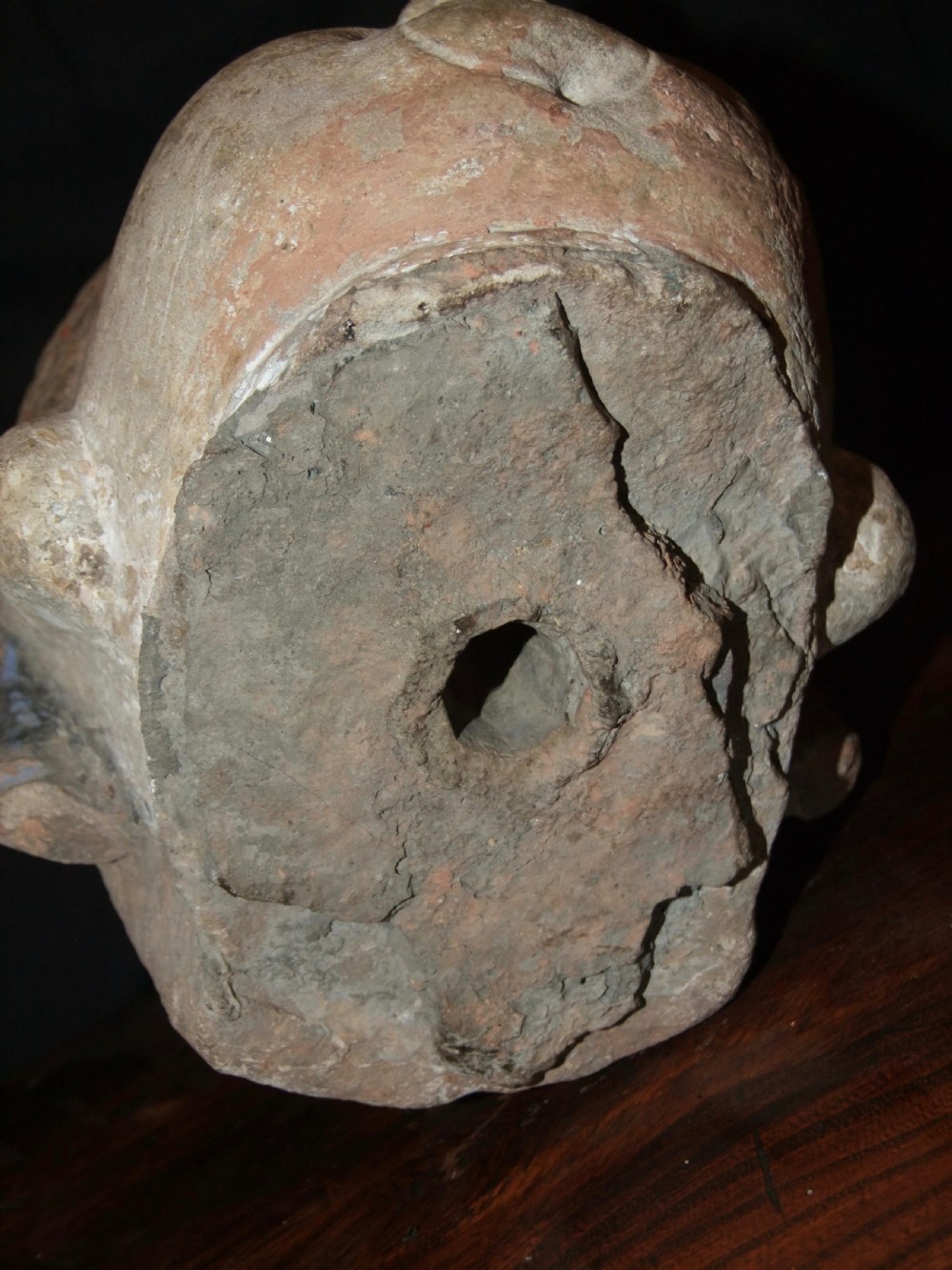 Carved sandstone head of Avalokiteshvara featuring an elaborate crown, gentle facial contours, and visible traces of red and green pigment. View IX