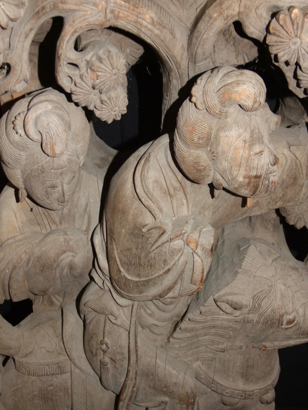 A pair of deeply carved natural timber architectural corbels depicting figures mounted on horses amidst floral motifs. View III