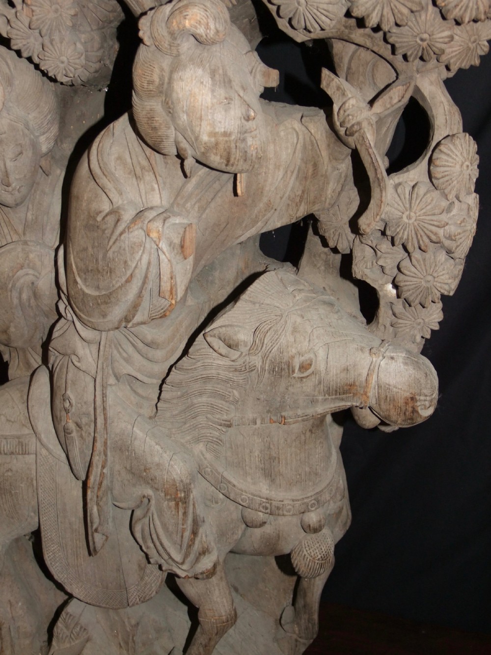 A pair of deeply carved natural timber architectural corbels depicting figures mounted on horses amidst floral motifs. View IV