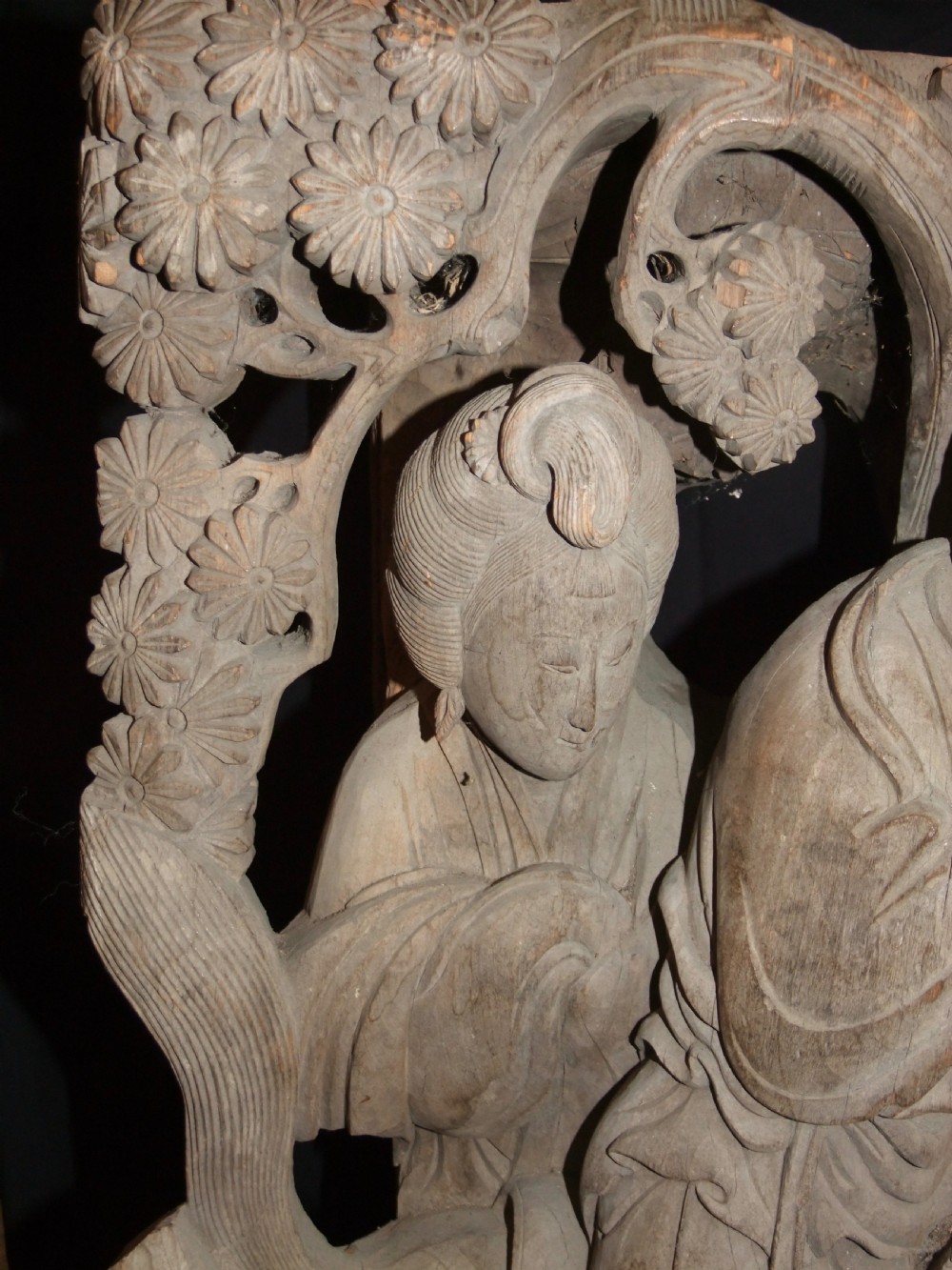 A pair of deeply carved natural timber architectural corbels depicting figures mounted on horses amidst floral motifs. View VI