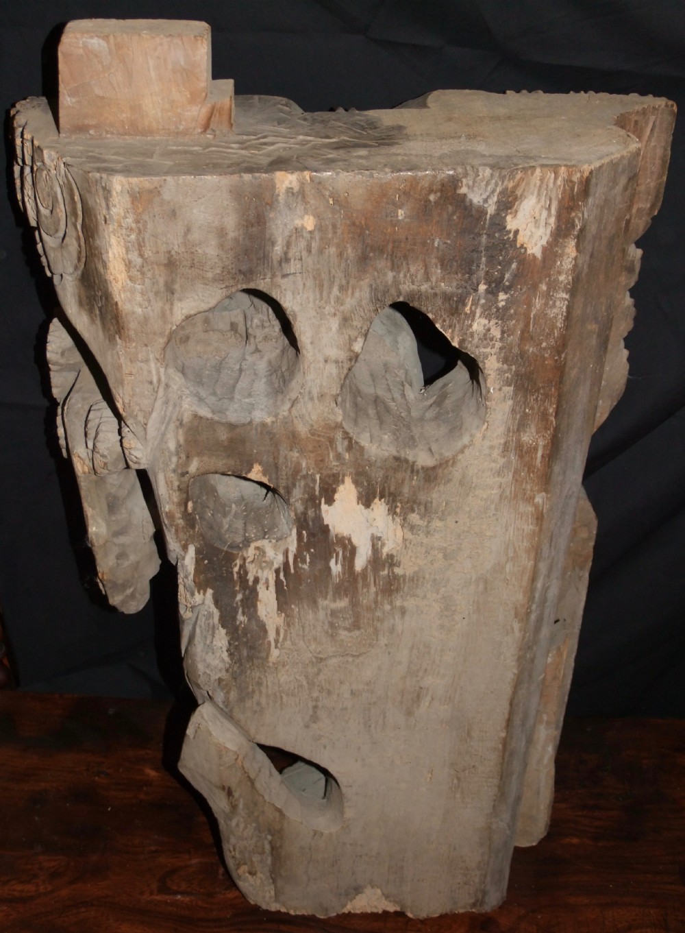 A pair of deeply carved natural timber architectural corbels depicting figures mounted on horses amidst floral motifs. View X