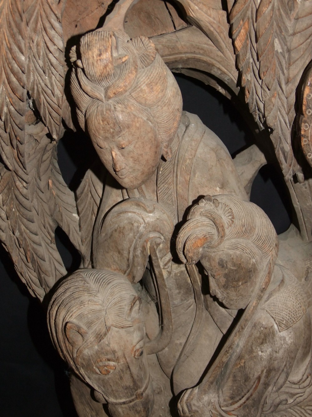 A pair of deeply carved natural timber architectural corbels depicting figures mounted on horses amidst floral motifs. View XII