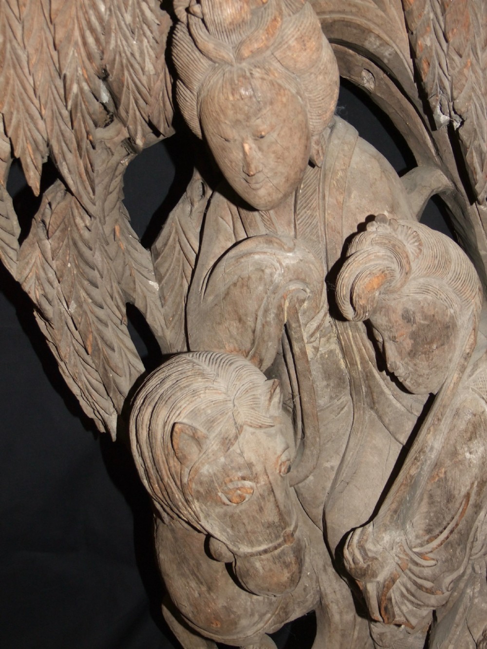 A pair of deeply carved natural timber architectural corbels depicting figures mounted on horses amidst floral motifs. View XIV