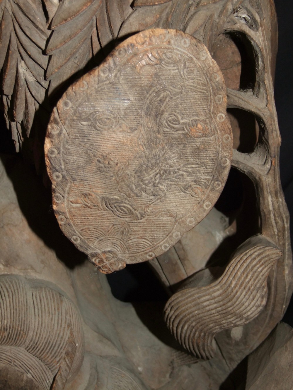 A pair of deeply carved natural timber architectural corbels depicting figures mounted on horses amidst floral motifs. View XV