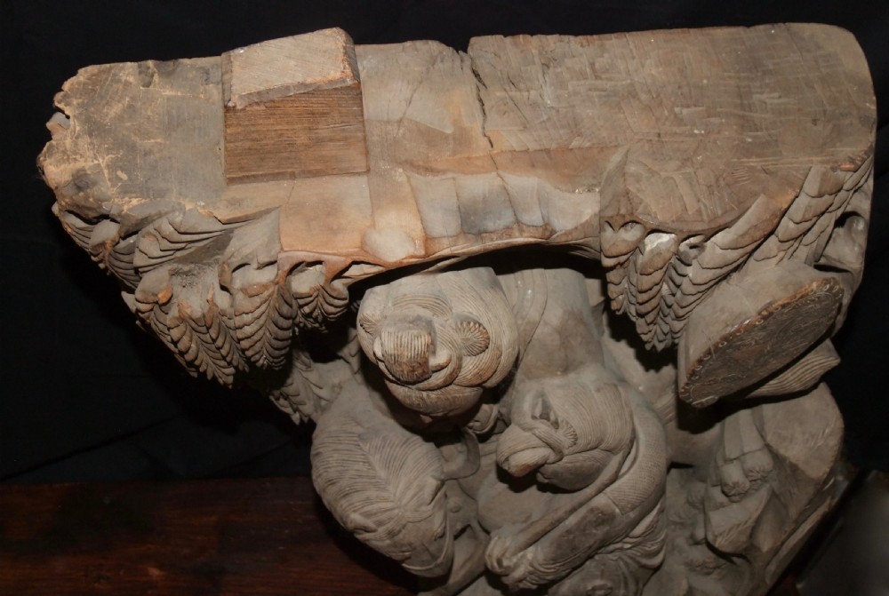 A pair of deeply carved natural timber architectural corbels depicting figures mounted on horses amidst floral motifs. View XVI