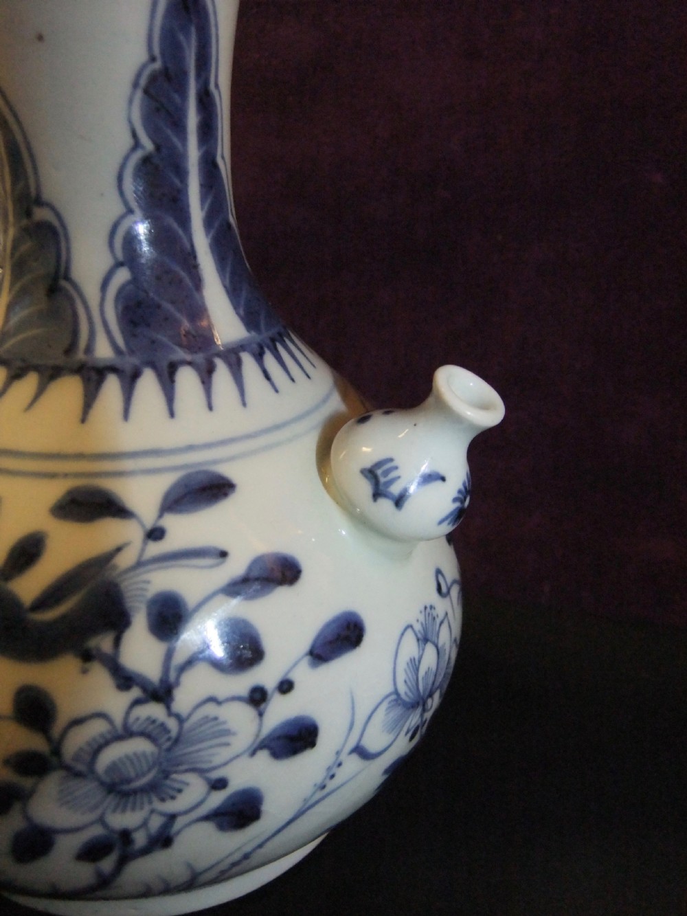 A Chinese blue and white porcelain kendi water vessel from the Kangxi period with floral and bird decoration and a bulbous side spout. View III