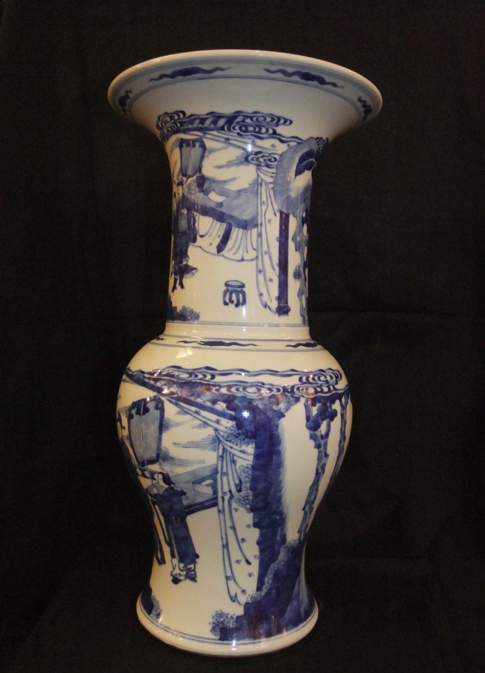 An antique Chinese blue and white porcelain Yen Yen vase featuring a flared trumpet rim and narrative figurative panels painted in underglaze cobalt blue. View II