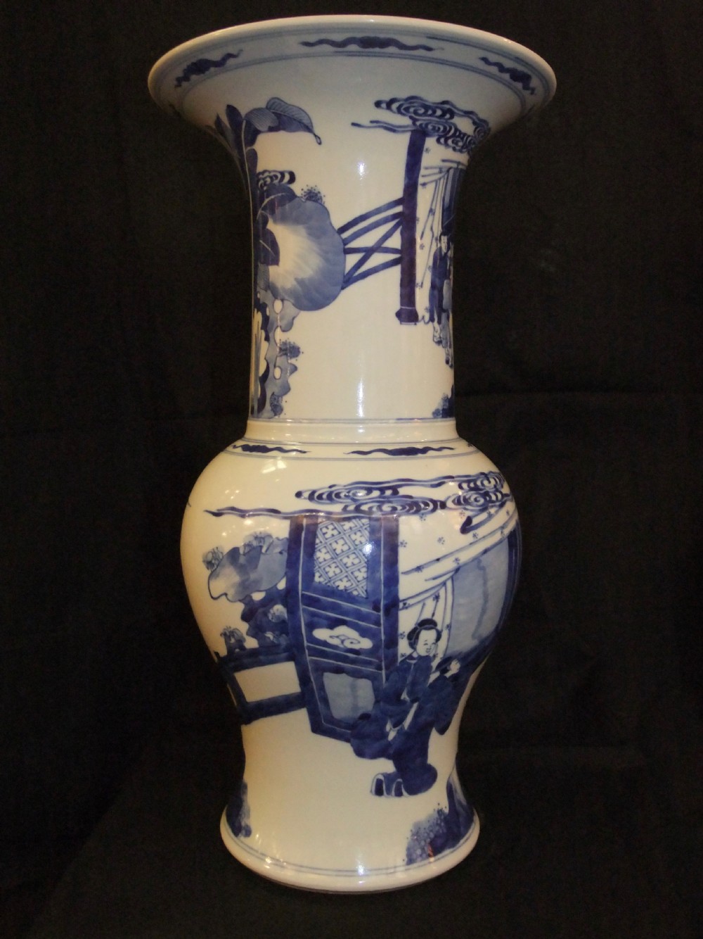 An antique Chinese blue and white porcelain Yen Yen vase featuring a flared trumpet rim and narrative figurative panels painted in underglaze cobalt blue. View IV