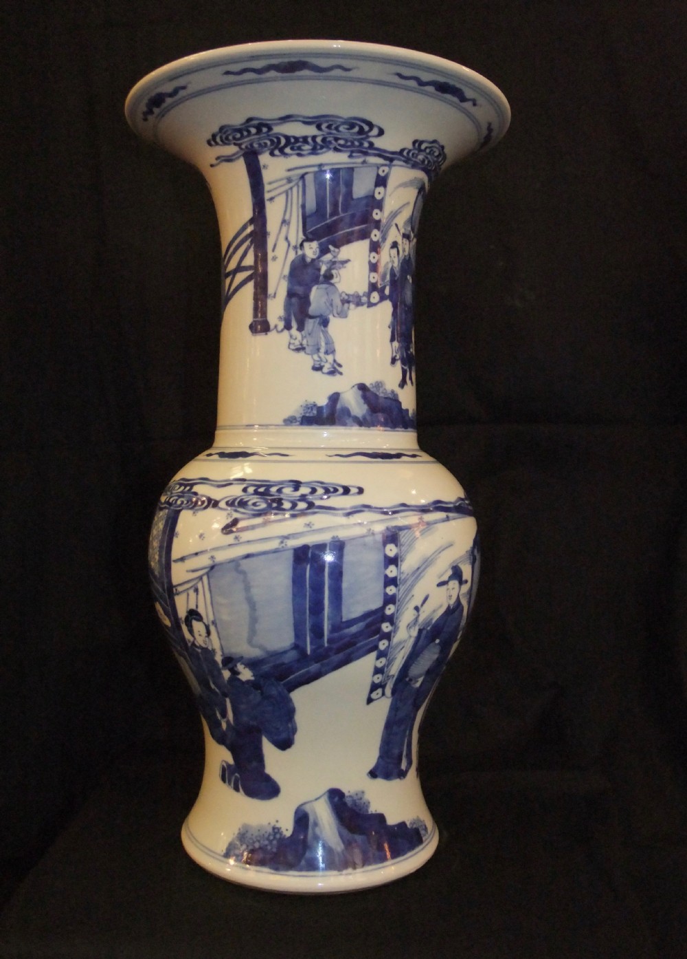 An antique Chinese blue and white porcelain Yen Yen vase featuring a flared trumpet rim and narrative figurative panels painted in underglaze cobalt blue. View V