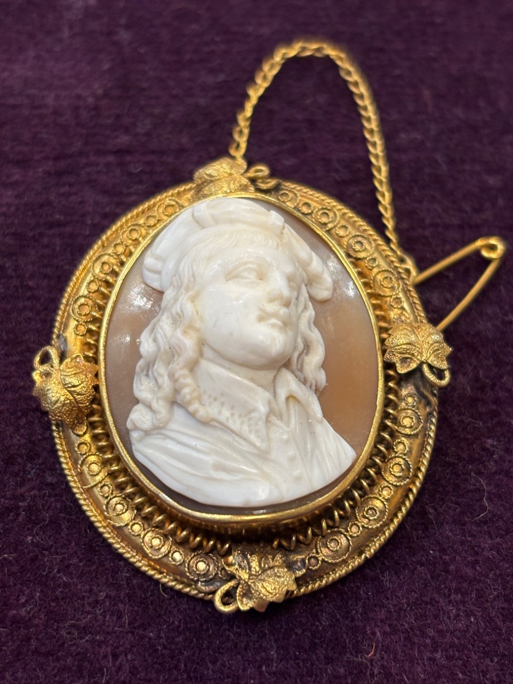 An oval early Victorian shell cameo featuring a carved relief portrait of Bonnie Prince Charlie within an intricate gold filigree border and safety chain. View II