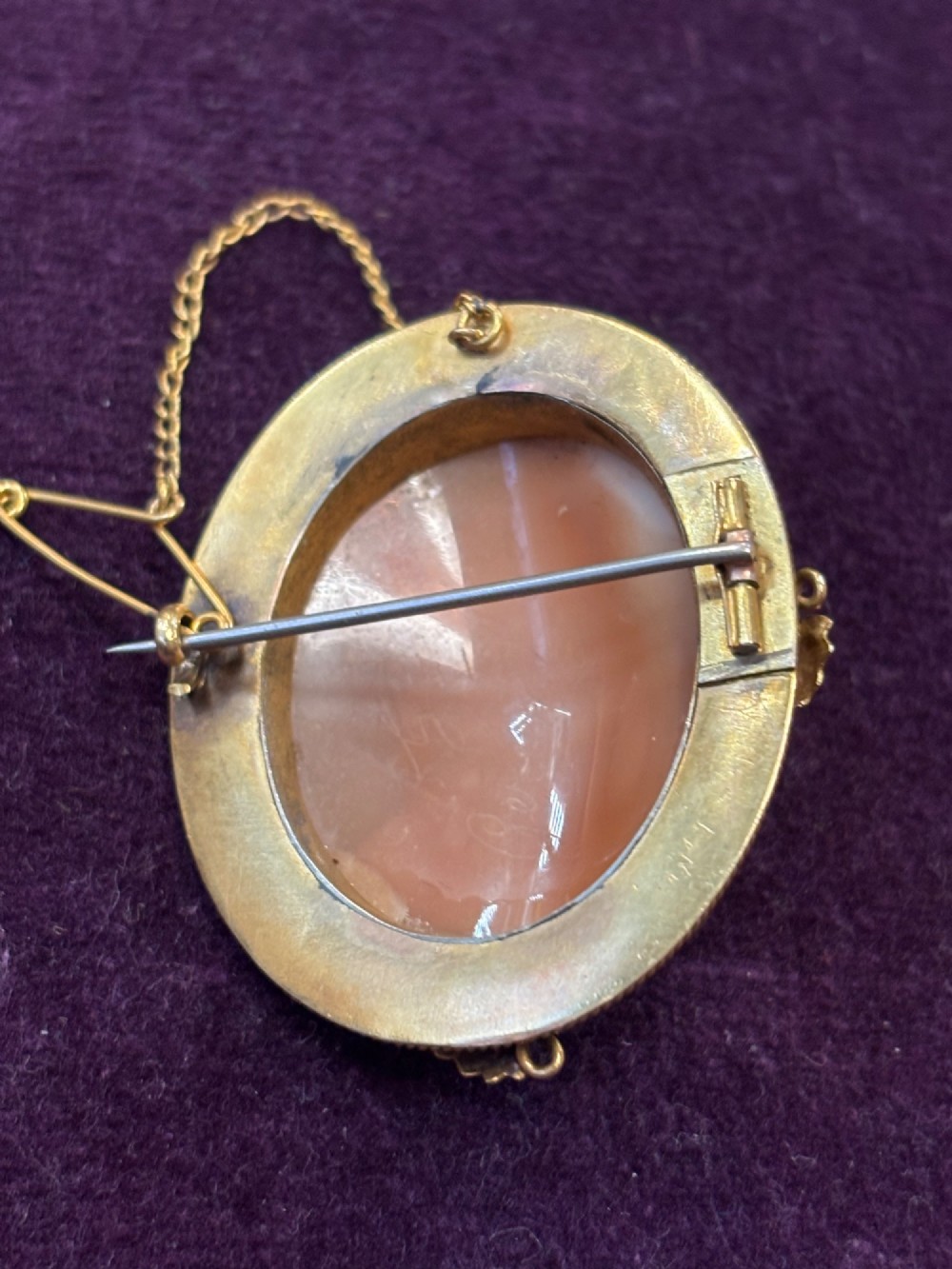 An oval early Victorian shell cameo featuring a carved relief portrait of Bonnie Prince Charlie within an intricate gold filigree border and safety chain. View IV