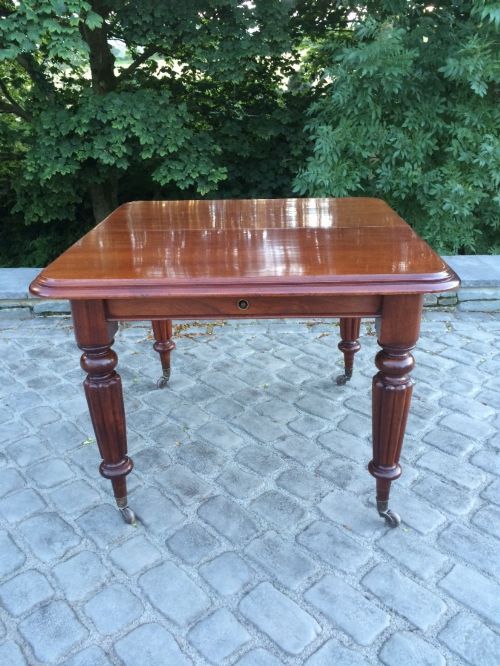 fig 1. A Victorian mahogany extending wind out dining table, circa 1850.