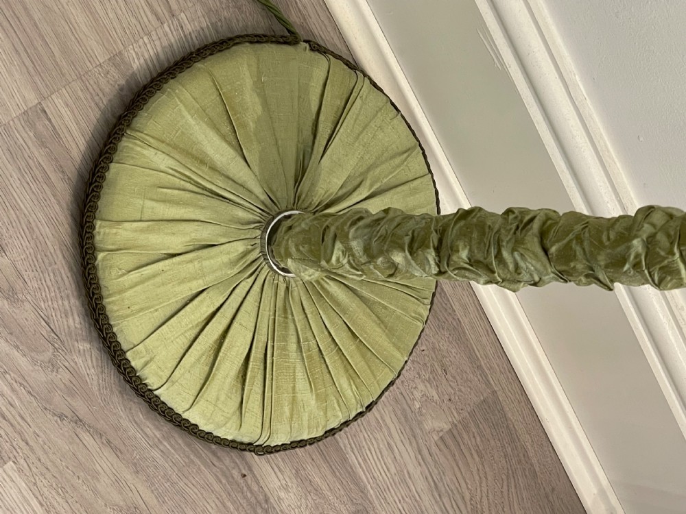 A 1930s standard lamp with gathered sage green silk fabric covering the central column and circular base, topped with a chrome bulb fitting. View III