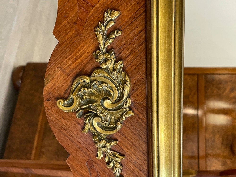 A late 19th-century French kingwood two-tier etagere table with gilt-bronze mounts, floral marquetry, and a glass-bottomed upper tray. View V