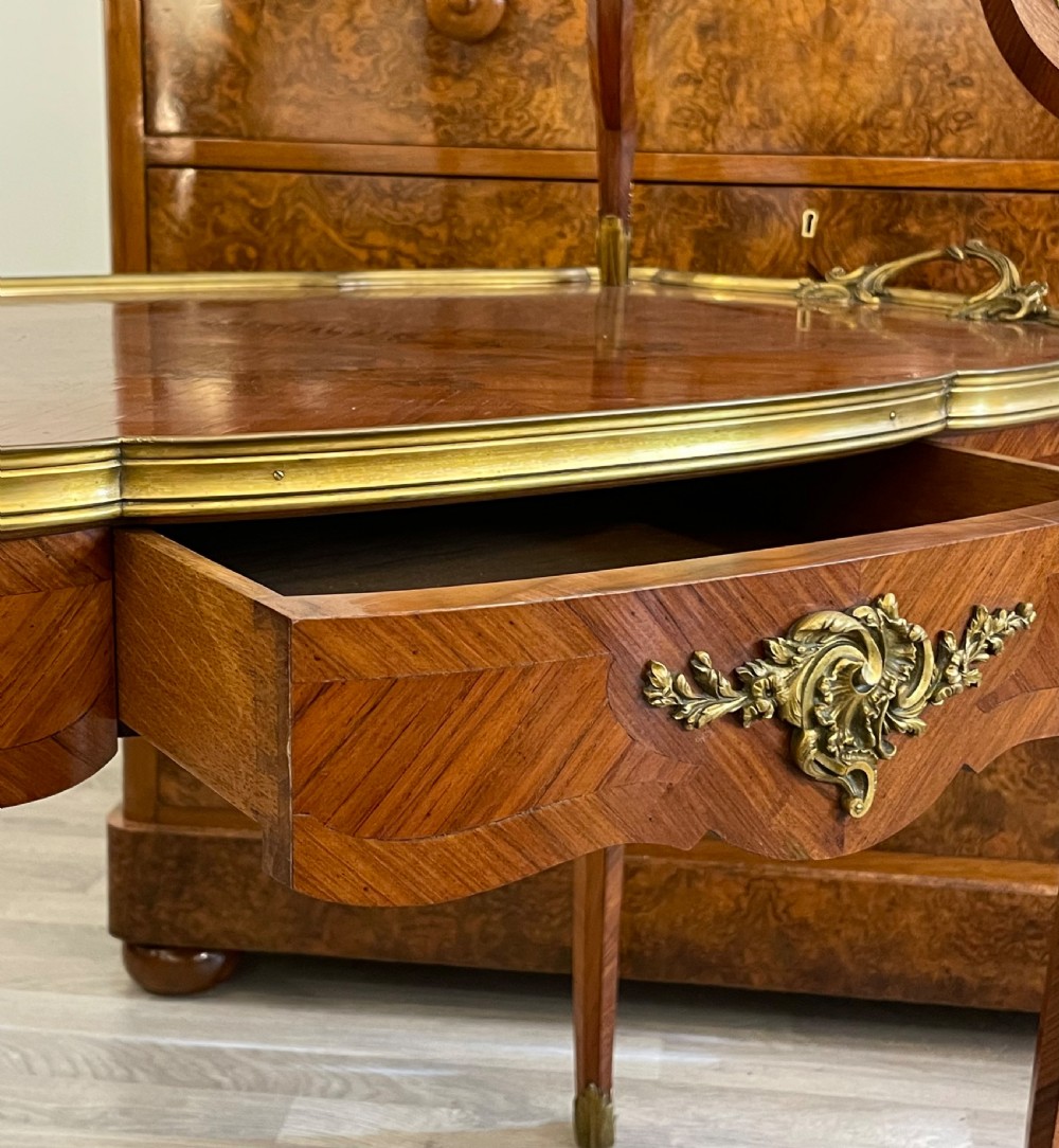 A late 19th-century French kingwood two-tier etagere table with gilt-bronze mounts, floral marquetry, and a glass-bottomed upper tray. View VII