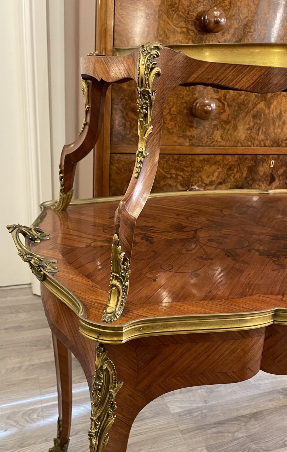 A late 19th-century French kingwood two-tier etagere table with gilt-bronze mounts, floral marquetry, and a glass-bottomed upper tray. View XI