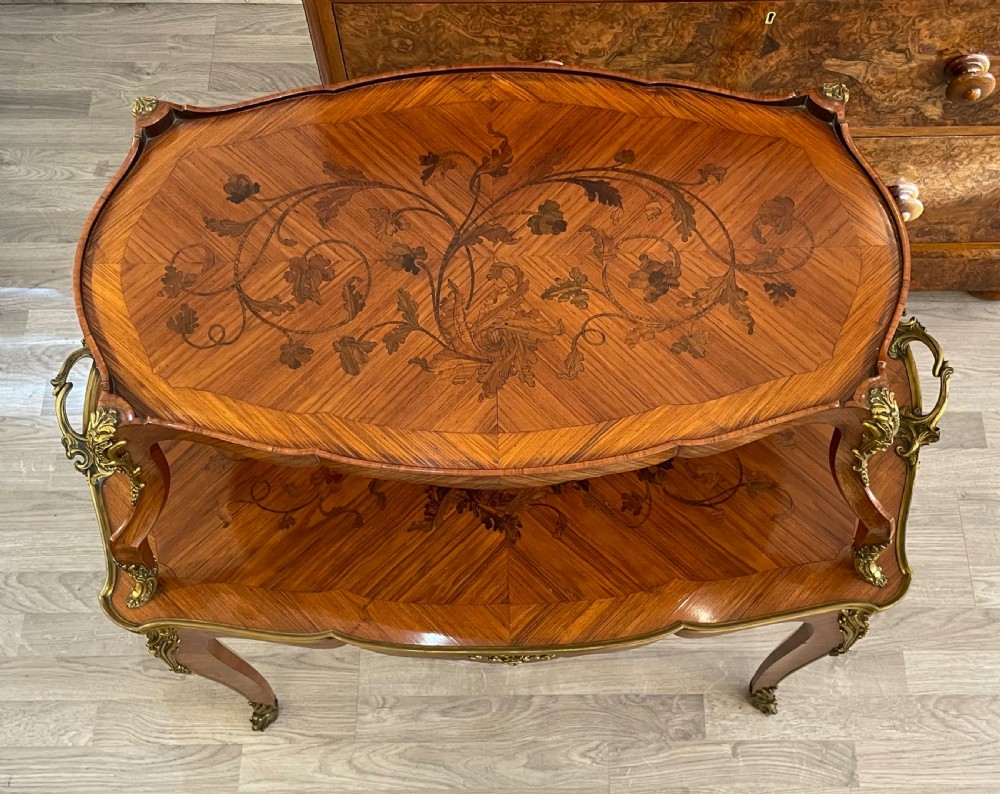 A late 19th-century French kingwood two-tier etagere table with gilt-bronze mounts, floral marquetry, and a glass-bottomed upper tray. View XII