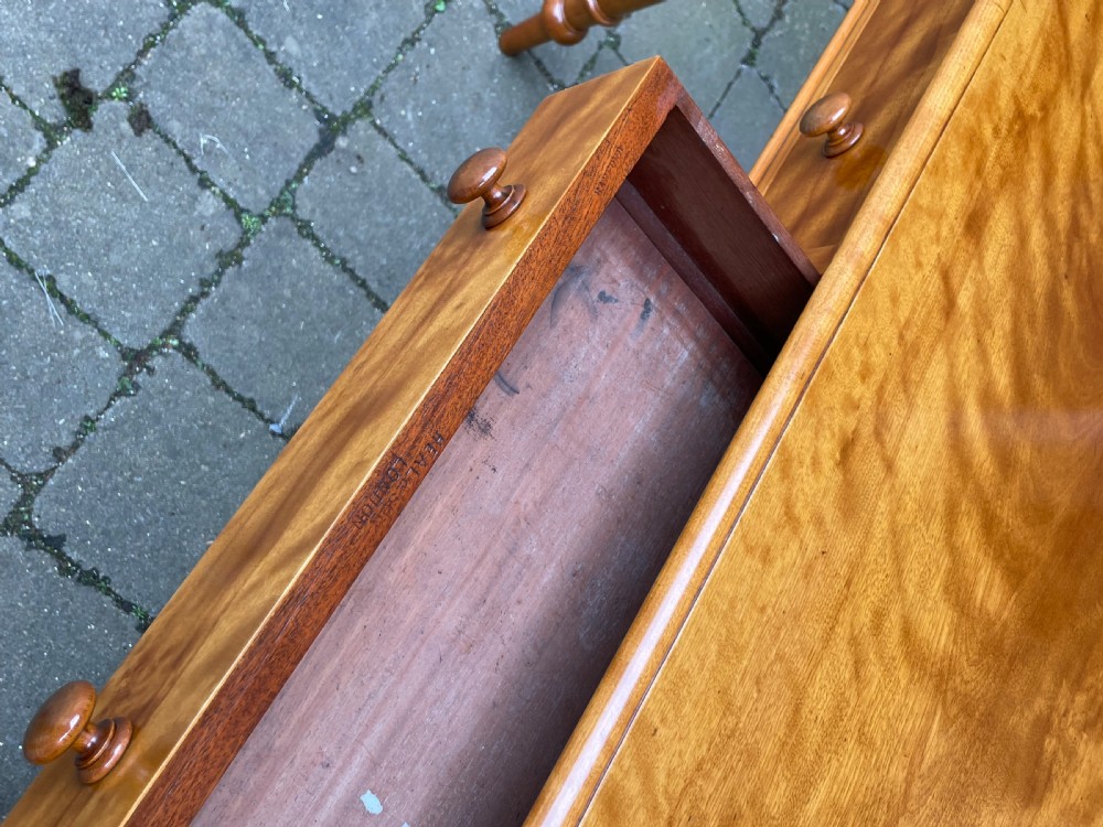 A Victorian satin birch side table featuring a low rear gallery, two front drawers with turned wooden knobs, and four turned tapered legs. View VIII