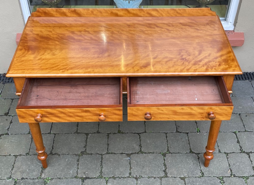 A Victorian satin birch side table featuring a low rear gallery, two front drawers with turned wooden knobs, and four turned tapered legs. View XI