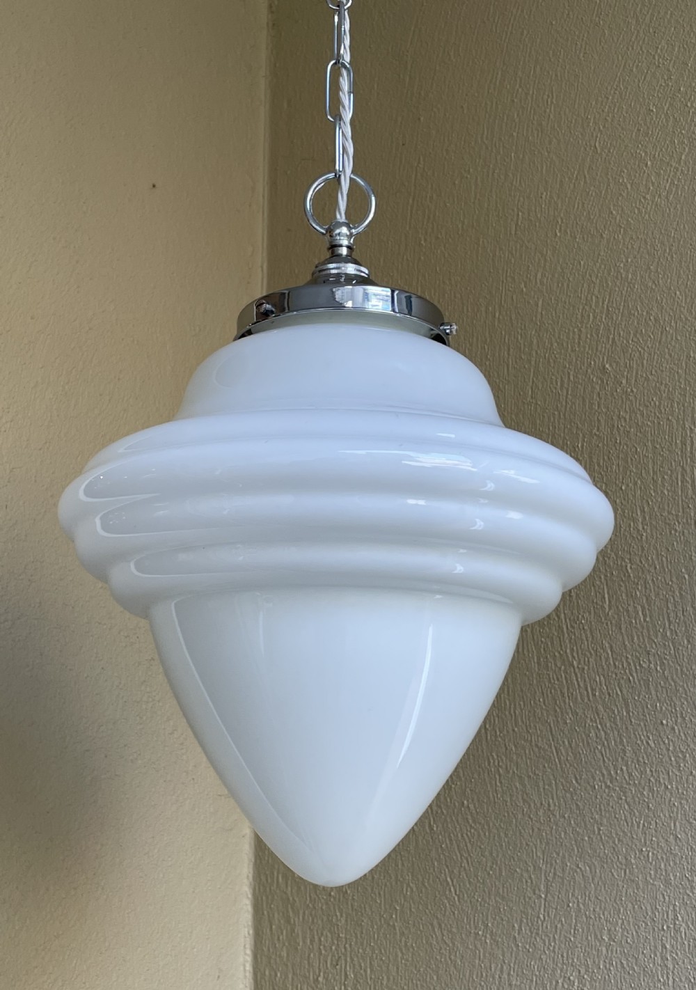 A white opaline glass pendant light with a reeded stepped profile, suspended by a chrome gallery and metal chain. View II