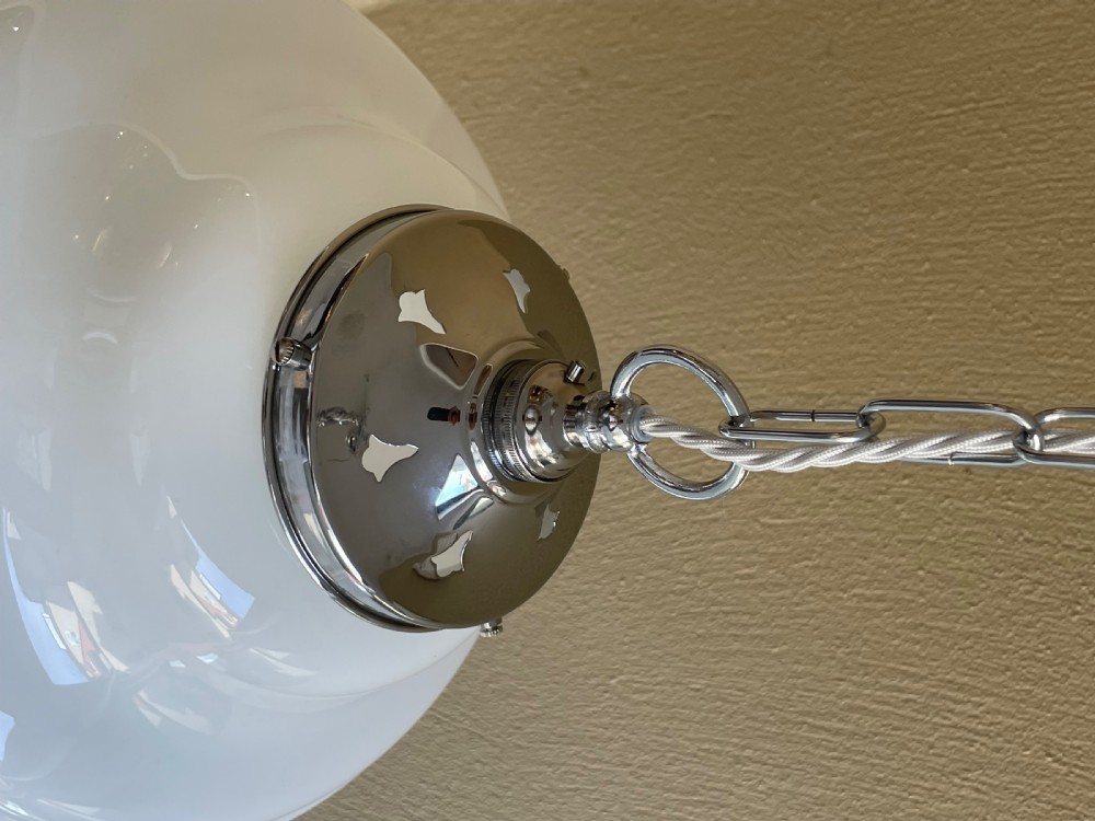 A white opaline glass pendant light with a reeded stepped profile, suspended by a chrome gallery and metal chain. View III
