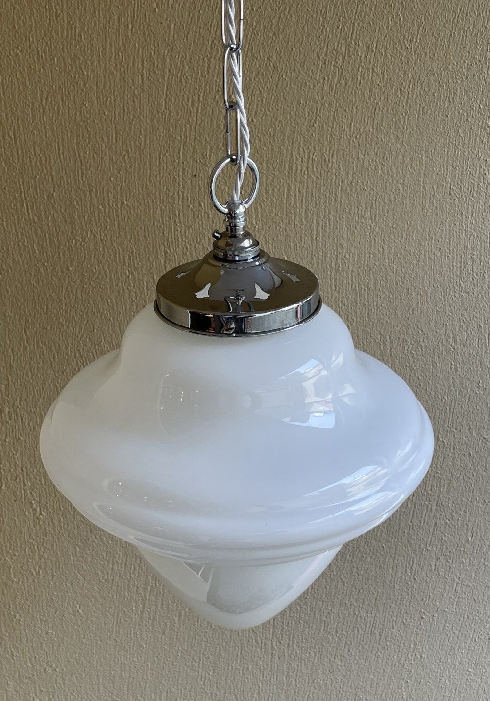 A white opaline glass pendant light with a reeded stepped profile, suspended by a chrome gallery and metal chain. View V