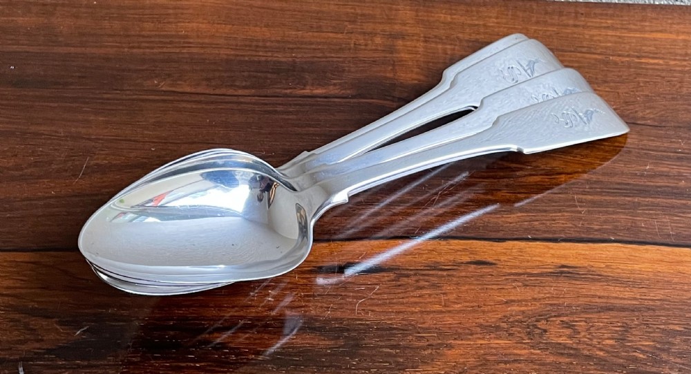A set of four Victorian Irish sterling silver table spoons with fiddle pattern handles and engraved monograms. View II