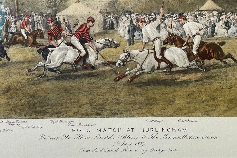 A framed nineteenth-century coloured lithograph depicting a polo match at Hurlingham with riders on horseback and spectators surrounding a green field, presented in a double mount and metallic frame. View IV