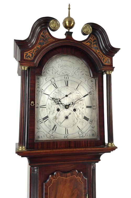 fig 2. A Scottish Georgian flame mahogany longcase clock featuring a swan-neck pediment, fluted quarter columns, and an engraved arched dial signed by John Breakenrig of Edinburgh.