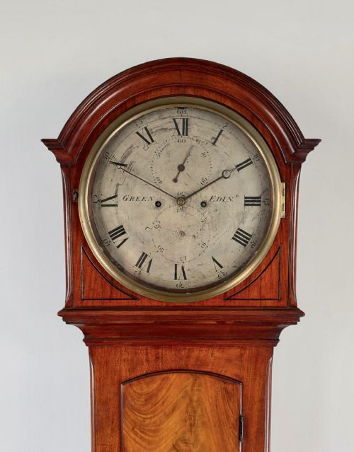 fig 1. A tall Scottish Georgian longcase clock crafted from flame mahogany with an arched hood and a circular silvered dial.