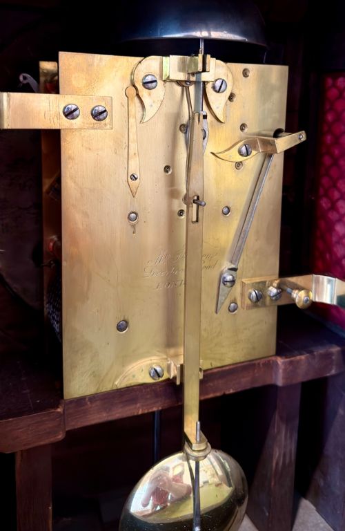 fig 1. A Regency mahogany bracket clock featuring a cream dial with Roman numerals signed Thomson London, set within a brass-inlaid wooden case.