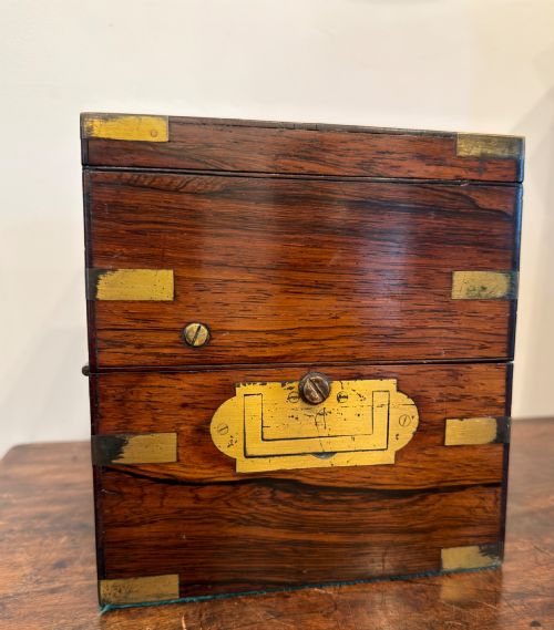 fig 1. A Thomas Mercer marine chronometer with a silvered dial and brass gimbal mechanism set inside an open mahogany box.