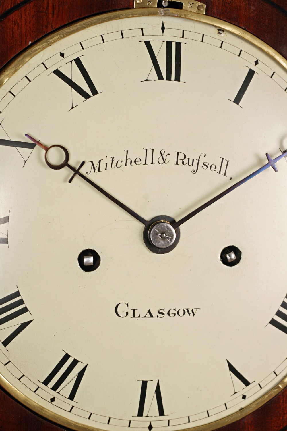 A Regency gothic arch mahogany bracket clock with brass lion mask side handles and a white dial inscribed Mitchell and Russell Glasgow. View IV