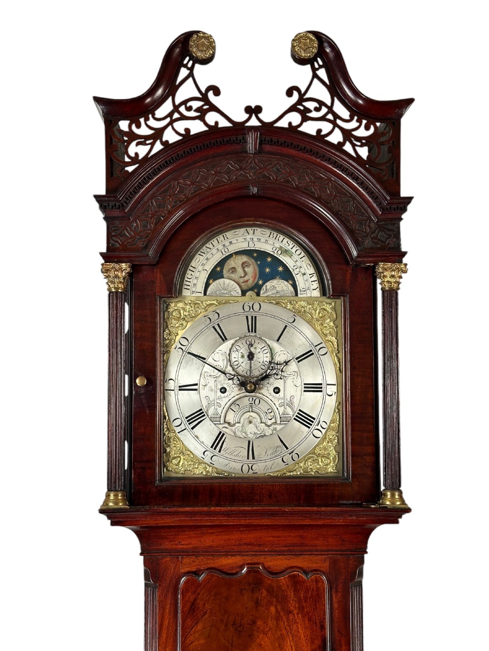 An antique Georgian mahogany longcase clock featuring a swan-neck pediment with pierced fretwork, a moonphase arch dial, and brass-mounted corner columns. View II