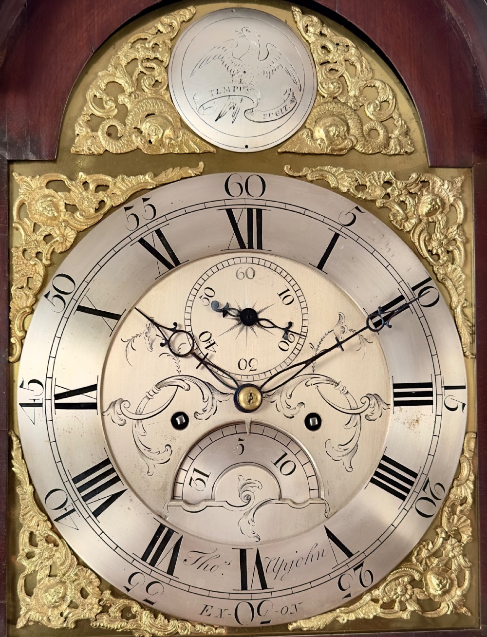 An eighteenth-century Georgian mahogany longcase clock featuring an arched hood with fluted columns and a silvered brass dial. View IV