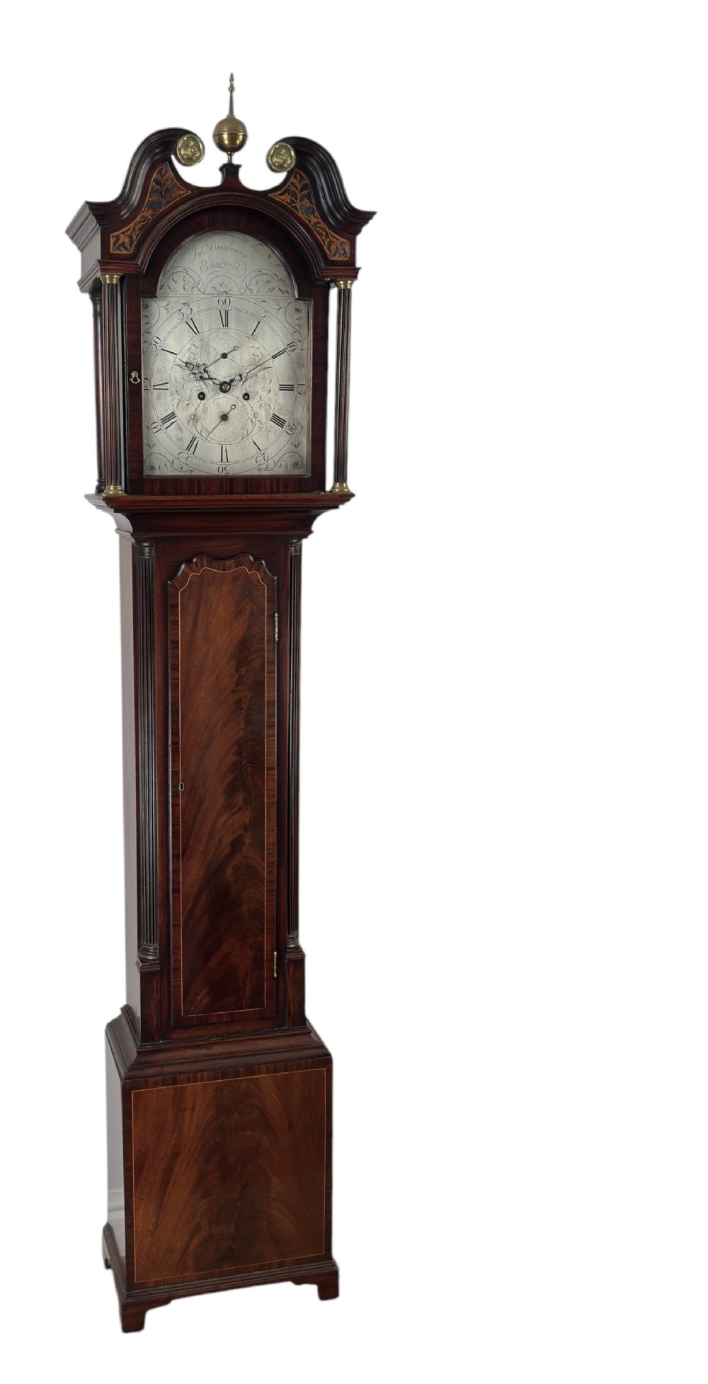 A Scottish Georgian flame mahogany longcase clock featuring a swan-neck pediment, fluted quarter columns, and an engraved arched dial signed by John Breakenrig of Edinburgh.