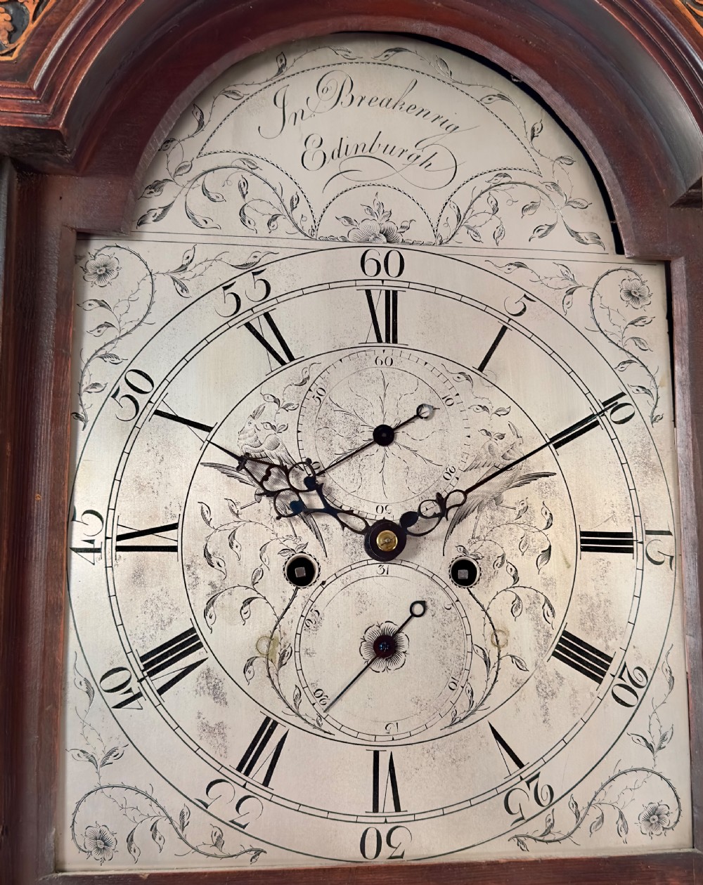 A Scottish Georgian flame mahogany longcase clock featuring a swan-neck pediment, fluted quarter columns, and an engraved arched dial signed by John Breakenrig of Edinburgh. View IV