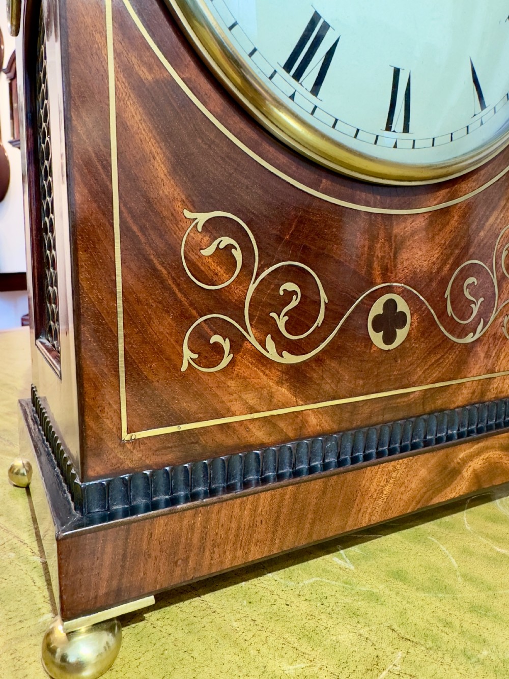An arched antique mahogany bracket clock with brass scroll inlay, lion-mask ring handles, and a white dial signed Hyde Salisbury. View V