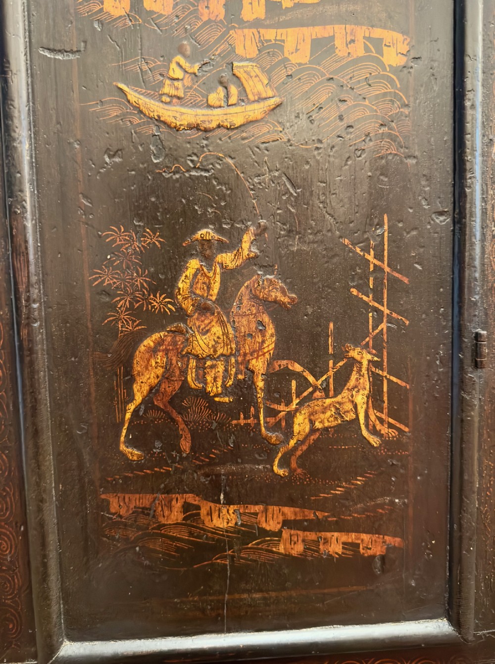 A tall, black lacquered longcase clock decorated with gold Chinoiserie landscapes, featuring a square brass dial with Roman numerals. View III