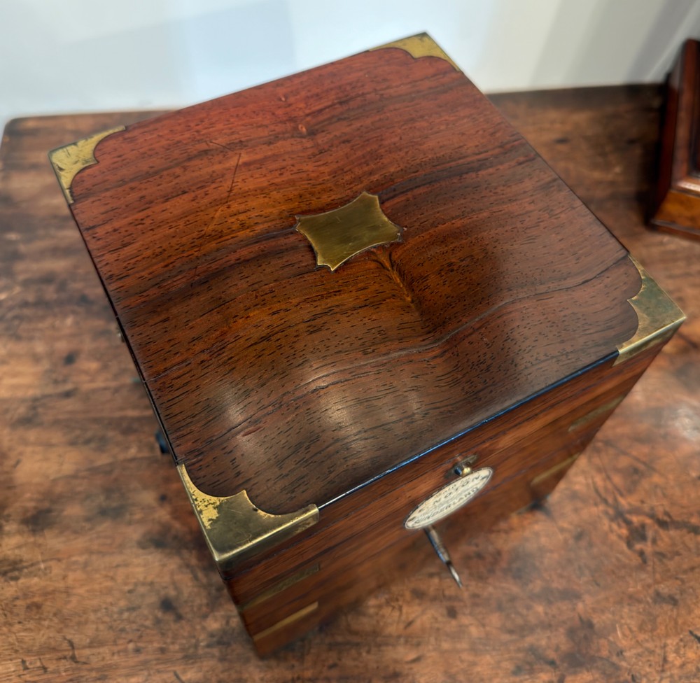 A Thomas Mercer marine chronometer with a silvered dial and brass gimbal mechanism set inside an open mahogany box. View III