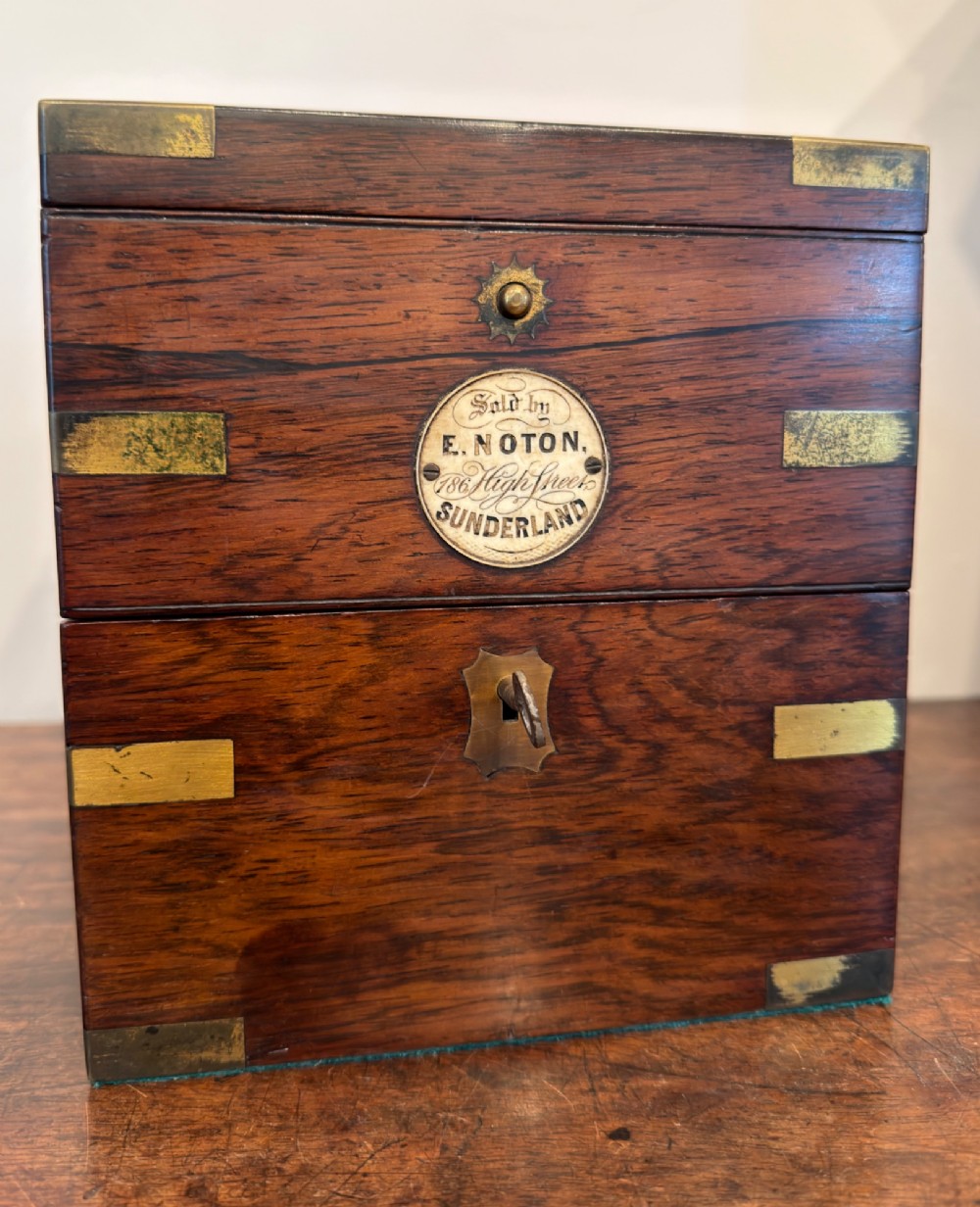 A Thomas Mercer marine chronometer with a silvered dial and brass gimbal mechanism set inside an open mahogany box. View VI