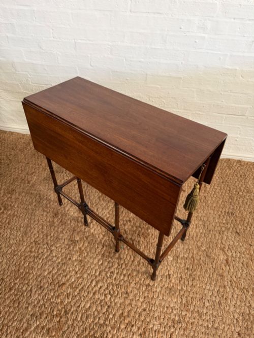 fig 1. An Edwardian solid dark mahogany drop-leaf side table featuring turned faux-bamboo legs, a central drawer with a key, and a double-tier stretcher base.