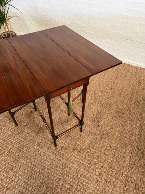 fig 2. An Edwardian solid dark mahogany drop-leaf side table featuring turned faux-bamboo legs, a central drawer with a key, and a double-tier stretcher base.