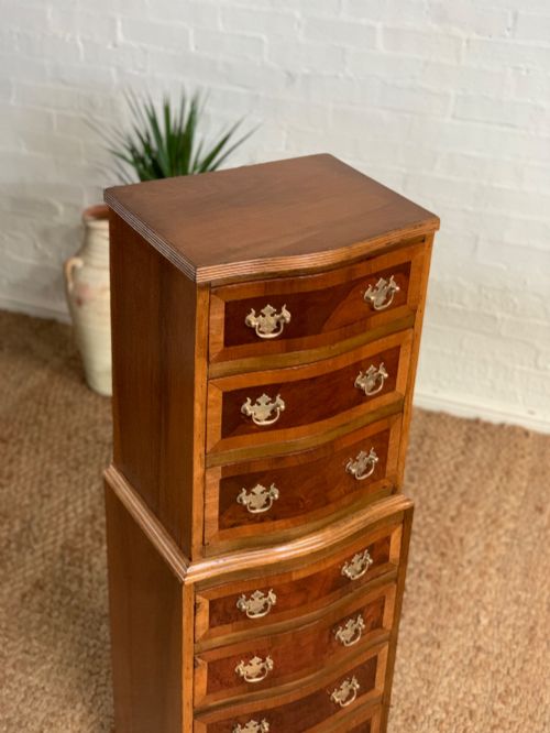 fig 4. A narrow Queen Anne style walnut tallboy featuring seven drawers in a two-piece stacked design with brass handles and cabriole legs.