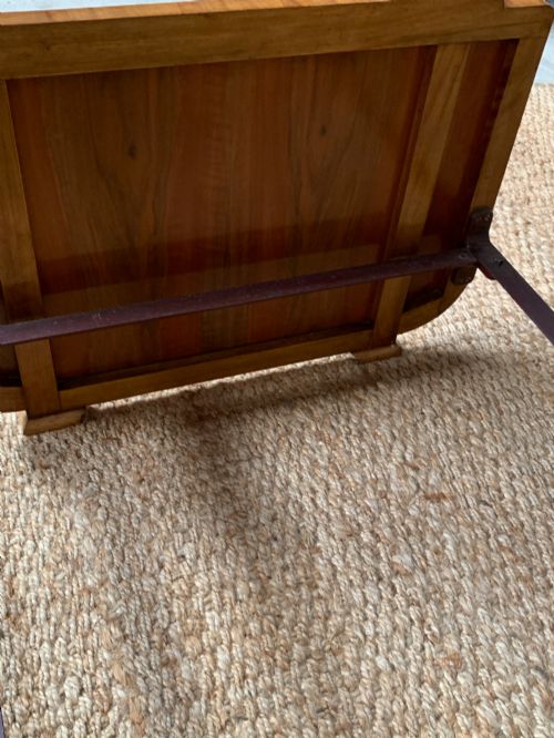 fig 4. An Art Deco single bed frame crafted from figured burr walnut veneer with crossbanded borders, featuring a gently arched headboard and rounded footboard.