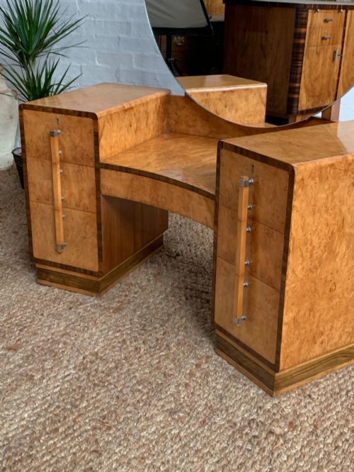 fig 1. An Art Deco burr walnut dressing table featuring a circular mirror, twin pedestals, and vertical drawer handles.