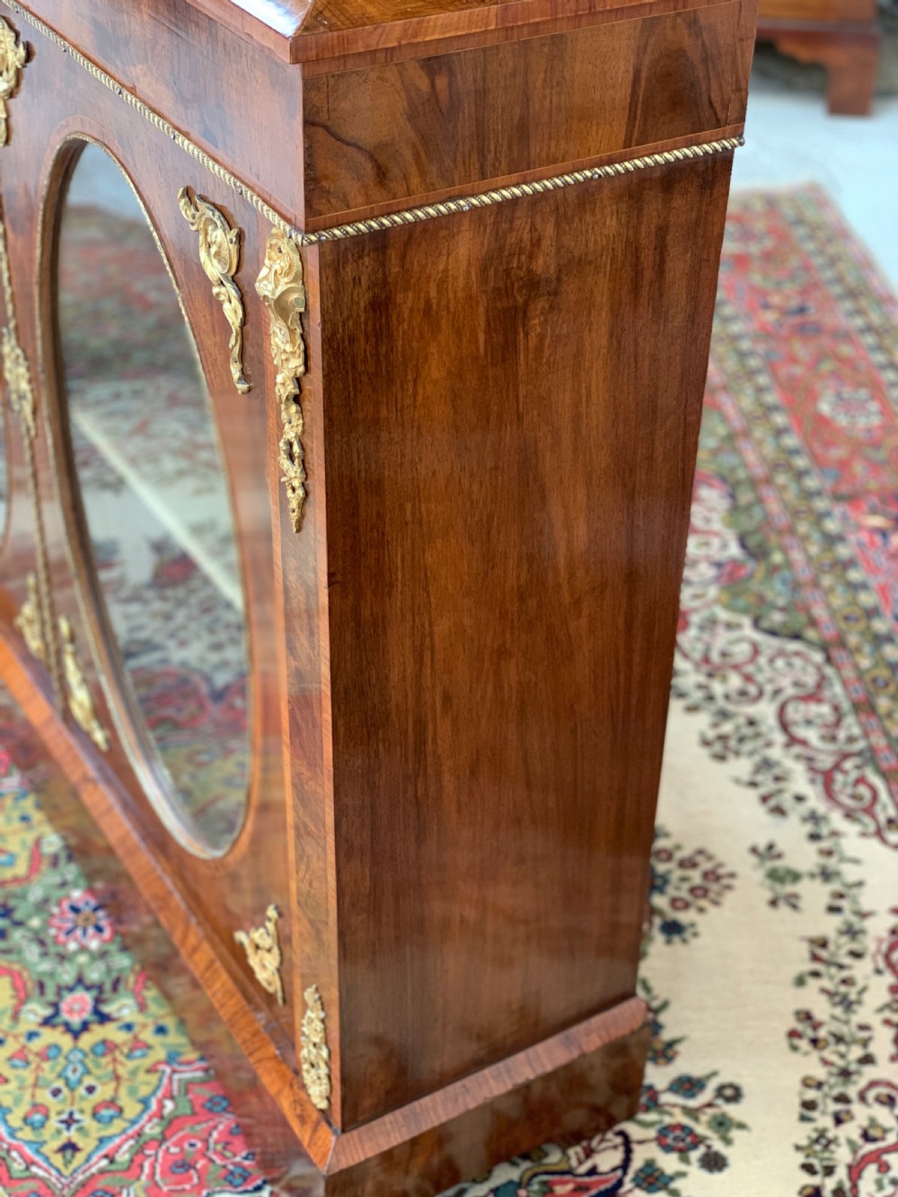 A Victorian double-door pier cabinet featuring figured walnut veneers, oval glass door panels, and decorative brass mounts. View XI