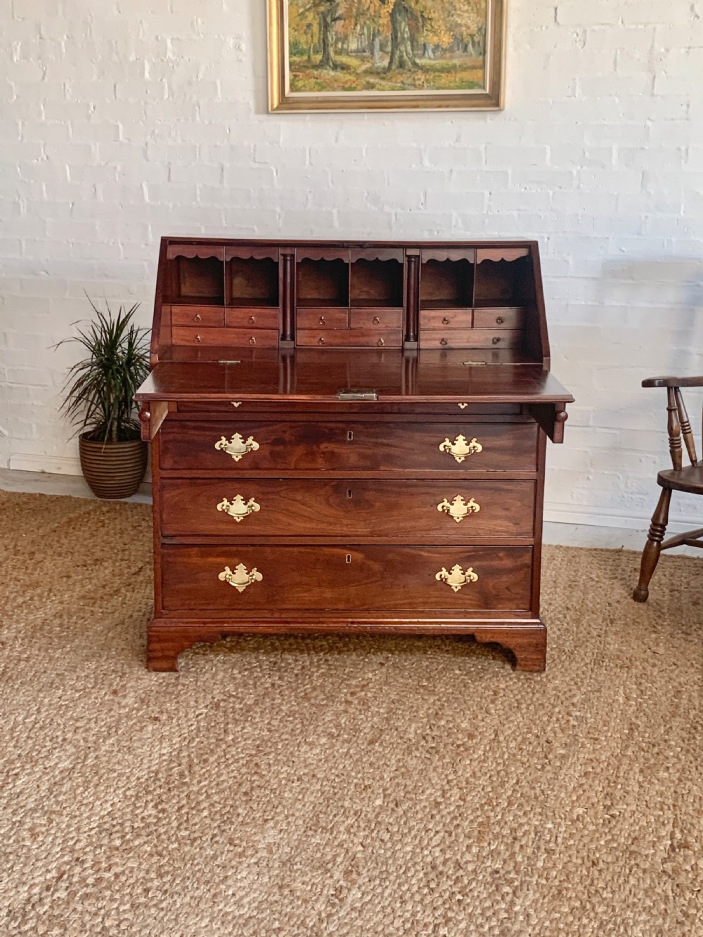 A Georgian mahogany slant-front writing bureau featuring four graduated drawers with brass batwing handles and bracket feet. View II