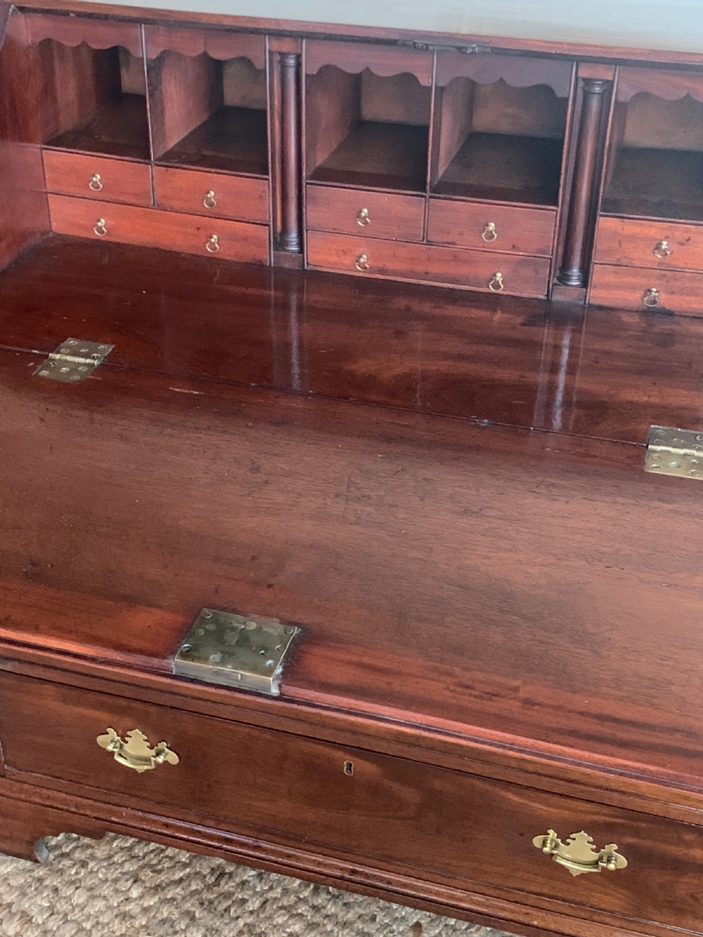 A Georgian mahogany slant-front writing bureau featuring four graduated drawers with brass batwing handles and bracket feet. View VIII