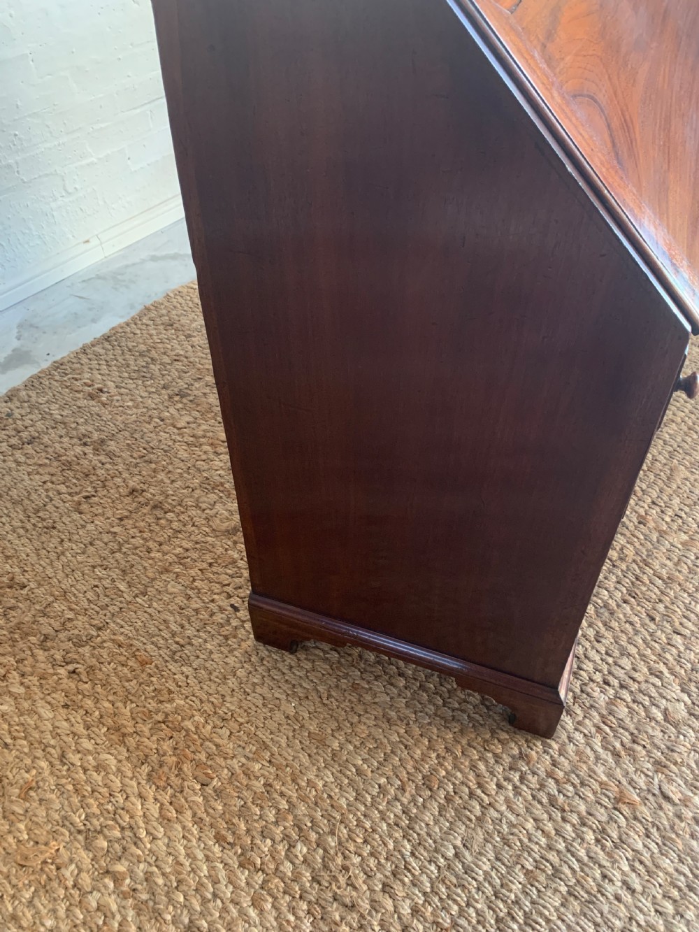 A Georgian mahogany slant-front writing bureau featuring four graduated drawers with brass batwing handles and bracket feet. View XI